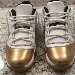 Air Jordan 11 Retro Gold and White Sneakers